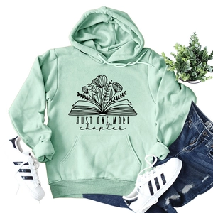 Mint green hoodie featuring 'Just One More Chapter' floral book print with kangaroo pocket