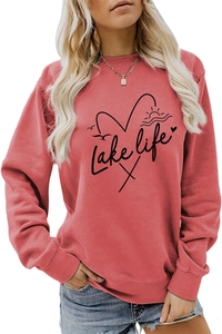 Close-up of Lake Life graphic print and soft fabric detail on coral crewneck sweatshirt