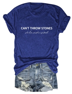 Flat lay of navy cotton T-shirt with white graphic print and distressed denim shorts