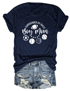 Flat lay of navy Boy Mom t-shirt with sports ball print and distressed denim shorts