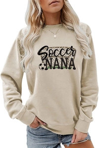 Detailed view of Soccer NANA graphic with leopard print and football on beige sweatshirt