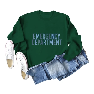 Flat lay of green crewneck sweatshirt with Emergency Department print and denim shorts
