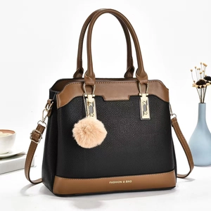 Chic large capacity shoulder bag in black and brown contrast leather with plush ball