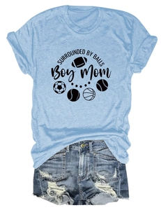 Detail of light blue Boy Mom t-shirt with sports ball graphics and denim shorts