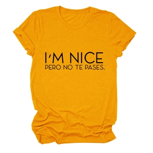 Detail of ginger yellow t-shirt with black I'M NICE PERO NO TE PASES printed text