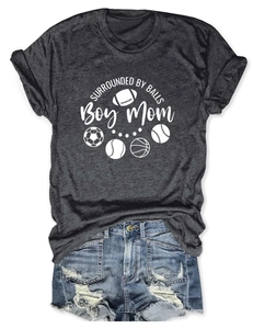 Flat lay of gray Boy Mom t-shirt and ripped denim shorts with sports theme graphic print