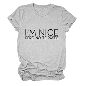 Detail of grey cotton T-shirt featuring I'M NICE PERO NO TE PASES slogan print