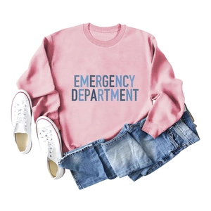 Flat lay of pink sweatshirt with Emergency Department print, jeans and white sneakers