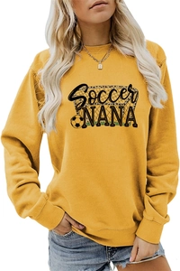 Close-up of Soccer Nana graphic print and football pattern on yellow sweatshirt