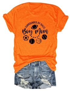 Detail of orange t-shirt with sports graphics and distressed denim shorts summer outfit