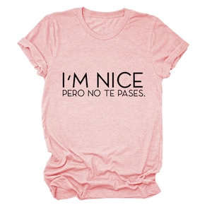 Close-up of I'M NICE printed slogan on light pink cotton short sleeve t-shirt