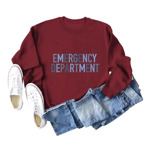 Flat lay of burgundy crewneck sweatshirt with Emergency Department print and blue jeans