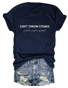 Flat lay of navy t-shirt with 'CAN'T THROW STONES' slogan and distressed denim shorts