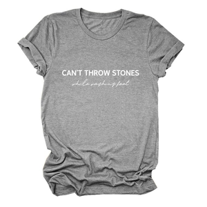 Detail of CAN'T THROW STONES text print on heather gray cotton crew neck t-shirt