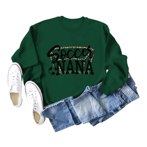 Dark green Soccer NANA sweatshirt flat lay with white sneakers and blue jeans