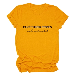Detail of soft mustard yellow cotton T-shirt featuring black slogan print and neckline