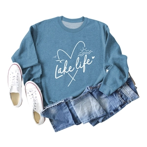 Mist blue Lake Life graphic sweatshirt with denim shorts and white canvas sneakers