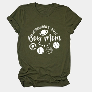 Close-up of olive green Boy Mom t-shirt featuring sports balls and white lettering