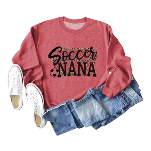 Flat lay of a red Soccer Nana crewneck sweatshirt with casual denim jeans and white sneakers