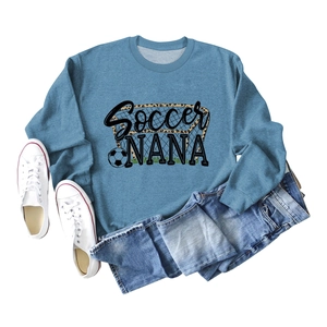 Flat lay of blue Soccer Nana crewneck sweatshirt with leopard print soccer ball detail