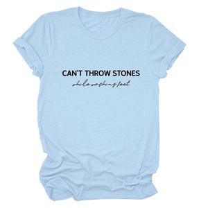 Detailed view of CAN'T THROW STONES print on a light blue cotton summer t-shirt