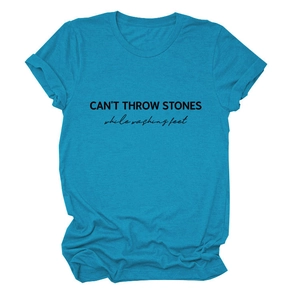 Close-up of black CAN'T THROW STONES text print on cyan cotton summer t-shirt