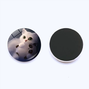 Close-up of 25mm round glass fridge magnet with cute cat illustration and magnetic back