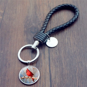 Handcrafted cardinal bird key chain with braided leather rope and time gem glass pendant