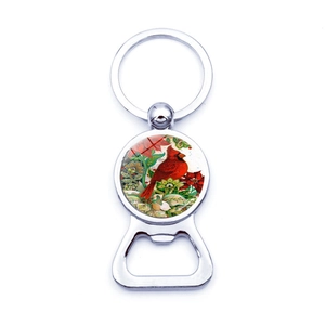 Detailed macro view of silver cardinal bird bottle opener keychain with artistic design