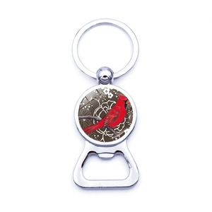 Detail of red cardinal bird bottle opener keychain with glossy glass cabochon finish