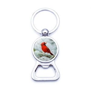 Polished metal cardinal bird keychain bottle opener with a scenic winter bird decoration