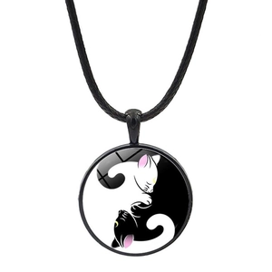 Detailed view of Yin Yang cat pendant necklace with glass cabochon and black cord