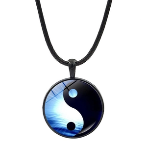 Detail of the yin-yang tai chi pendant with butterfly patterns and black rope
