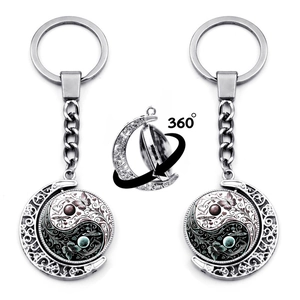 Vintage 360-degree rotating silver keychain featuring Tai Chi butterfly and moon designs