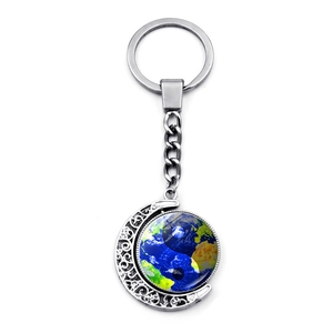 Detail of Yin Yang butterfly keychain featuring a rotating double-sided glass pendant