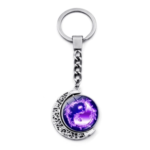 Macro detail of rotating yin yang butterfly pendant on silver stainless steel keychain