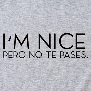 Gray knitted t-shirt featuring I'M NICE PERO NO TE PASES artistic letter printing
