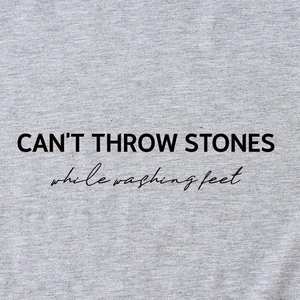 Grey T-shirt with black CAN'T THROW STONES lettering and soft cotton fabric texture