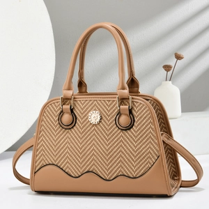 Minimalist beige shell crossbody bag featuring herringbone weave and brown leather trim
