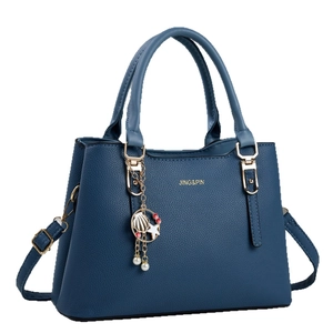 Navy blue lychee texture tote bag with sea-themed gold pendants and adjustable strap