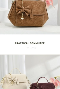 Close-up of suede crossbody bag with bow detail, pearl pendant, and gold chain