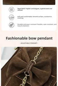 Detail of dark brown wool fabric texture with large bow pendant and gold chain