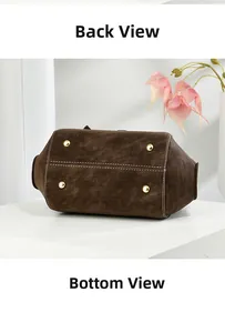 Detailed bottom view of dark brown leather handbag featuring golden metal protective studs