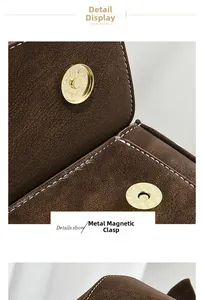 Macro shot of gold magnetic buckle and lychee grain leather texture on brown bag