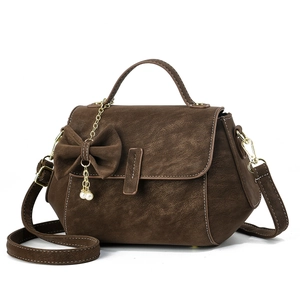 Dark brown suede crossbody bag with elegant bow, pearl charms and gold chain strap