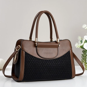 Close-up of color-block pillow bag with woven texture, leather trim and gold hardware