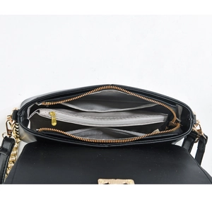 Detail view of the black shoulder bag interior with multiple compartments and gold zippers