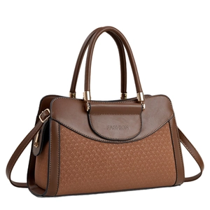 Brown patchwork crossbody pillow bag with woven texture and gold-tone hardware detail
