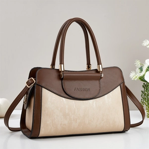 Detailed macro view of two-tone brown tote bag featuring fine vertical silk textures