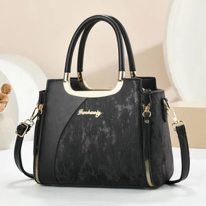 Elegant black leather handbag with grey textured panels and golden metal hardware detail
